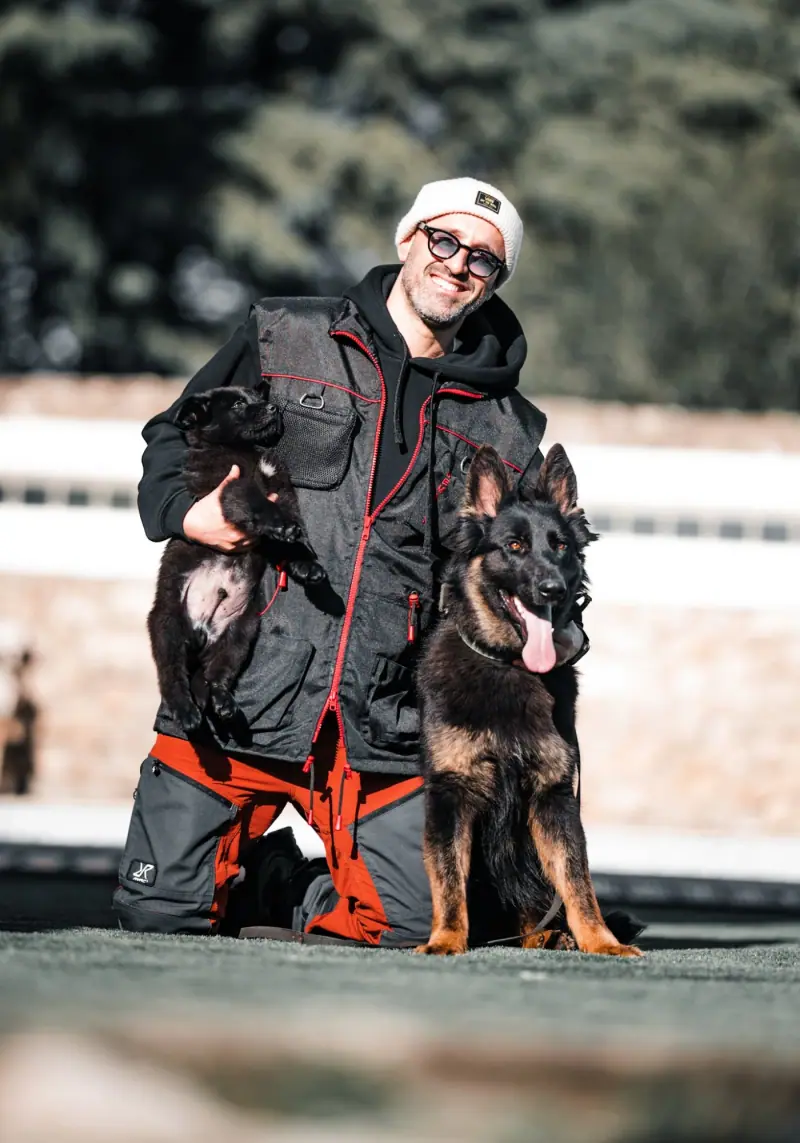 Rui Navarro with a German Shepherd and puppy